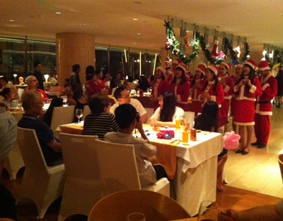 Choral singing as Christmas wishes to foreign tourists at Feast Restaurant, Sheraton Nha Trang Hotel.