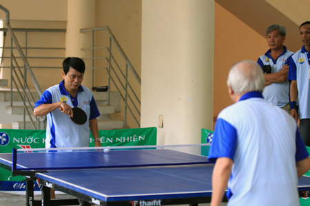 Players competing in table-tennis.