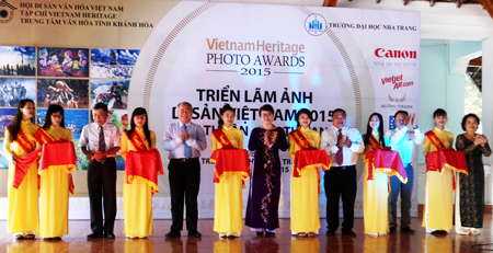 Representatives cutting ribbon to open exhibition.