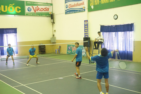 Players competing in men’s badminton.