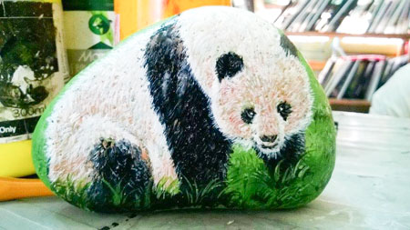 Panda painted on pebble.