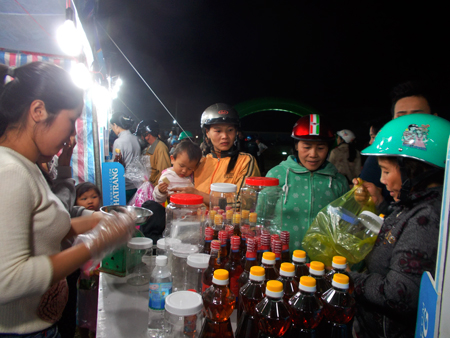 People buying goods at market day bringing products to rural areas in 2015.