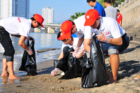 Collecting garbage on beach.