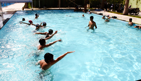 Pupils learning to swim at Yet Kieu Swimming Pool.