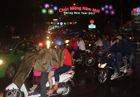 Streets filled with people despite rain.