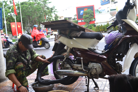 Ty is a vehicle repairer on Nguyen Chanh Street.