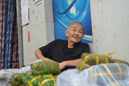 Aged woman selling spring roll on To Vinh Dien Street.