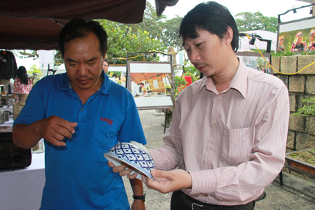 Antique collector contemplating a porcelain bowl of Ming Dynasty (China).