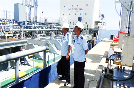 Customs officers supervising petroleum warehouse