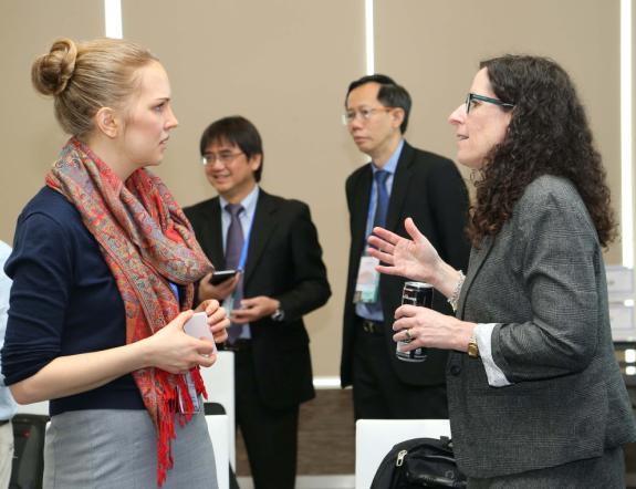 Delegates talk outside the meeting hall.