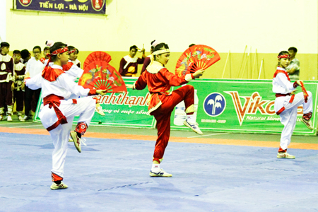 Martial arts practitioners of Nha Trang Traditional Martial Arts Unit performing with fans.