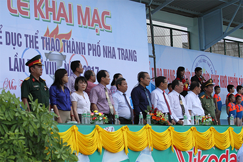 Representatives saluting national flag.