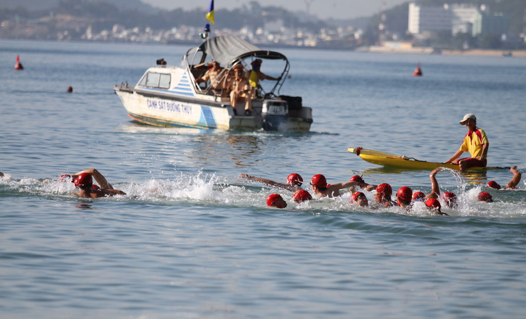 Male participants competing in swimming event.