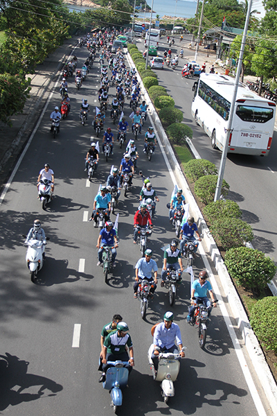 Vintage vehicles parade on Pham Van Dong Street.