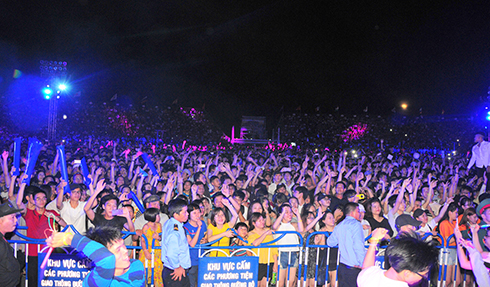 Audience enthusiastically engage in EDM night.