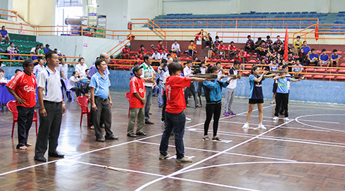 Players competing in crossbow shooting event.