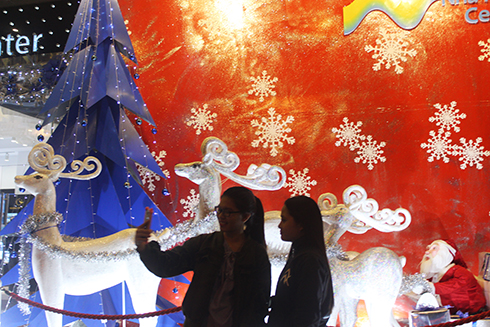 Taking selfie with Christmas decorations.