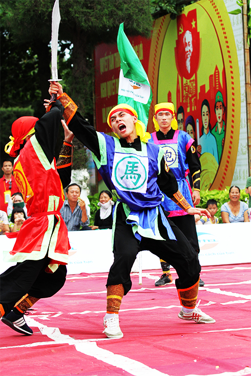 Martial arts practitioners performing martial arts techniques at human chess competition