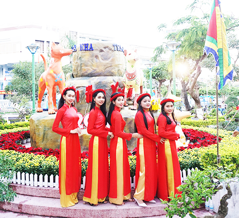 Young people posing with decorations.