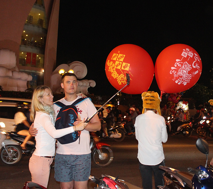 Foreign tourists capturing memories of Vietnamese’s Tet.