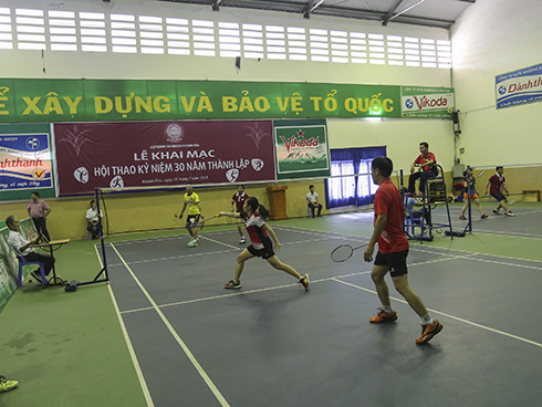 Players competing in badminton