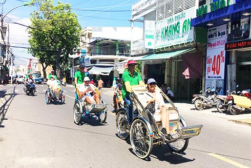 Cruise tourists going around Nha Trang City by cyclo.