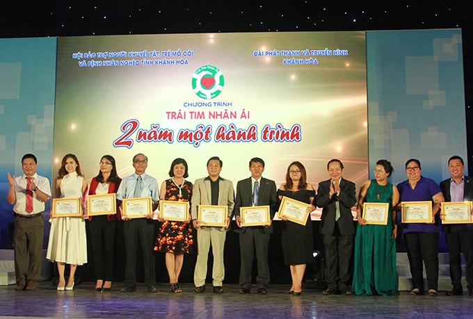 Representatives of organization committee offering merit certificates acknowledging contributions to benefactors 