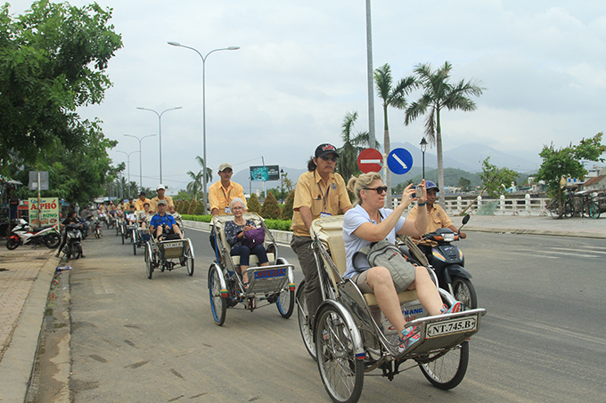 Tourists riding on cyclos in Nha Trang