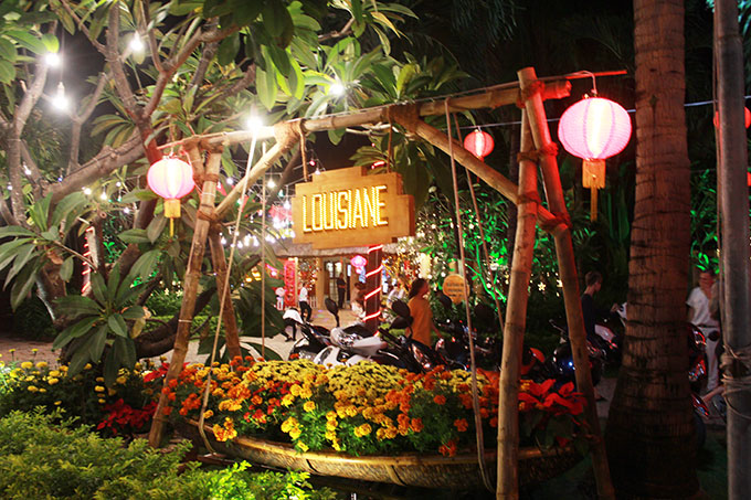 Boat carrying flowers in front of Louisiane Brewhouse Nha Trang