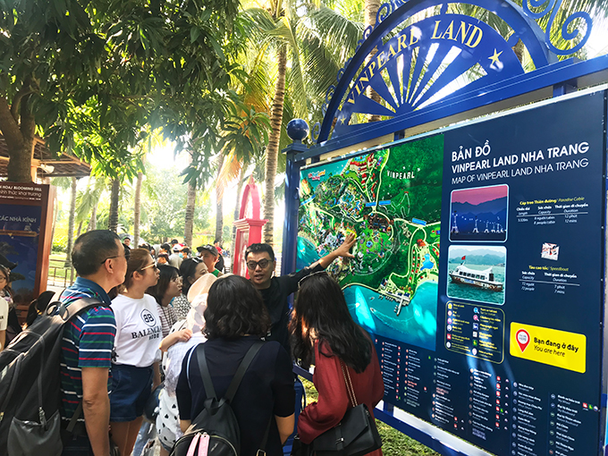 Tour guide showing tourists about Vinpearl Land