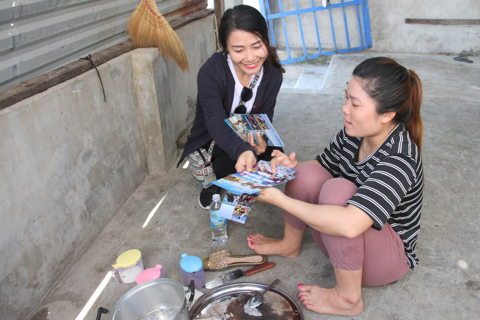 A volunteer distributing environmental protection leaflets to people on Tri Nguyen Island