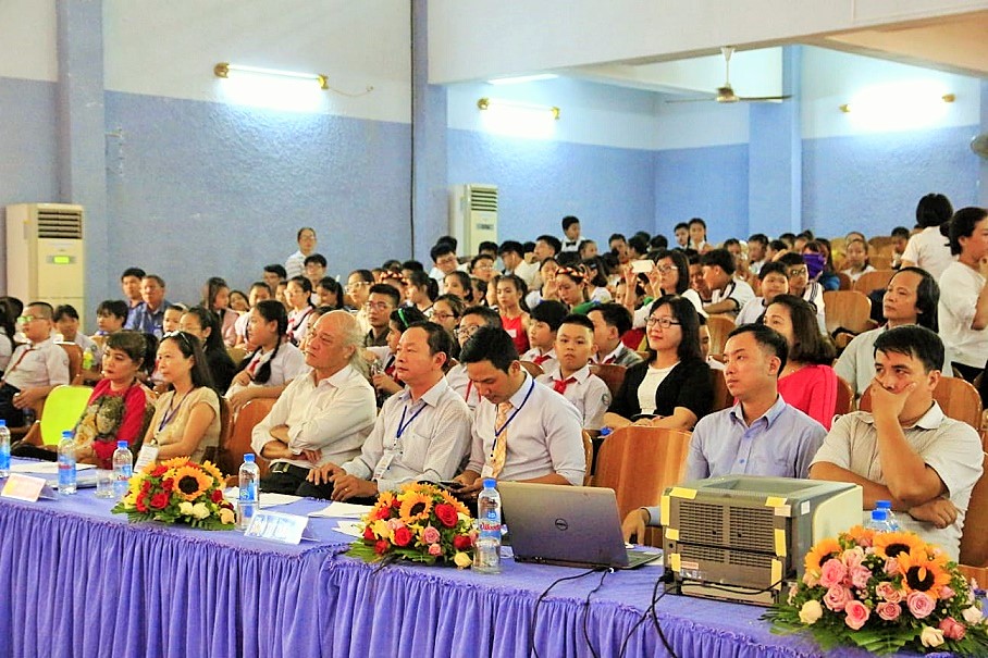 Representatives, teachers, parents, and pupils watching performances