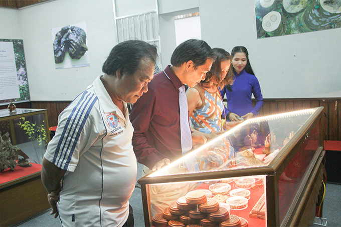 Visitors contemplating aloe wood products