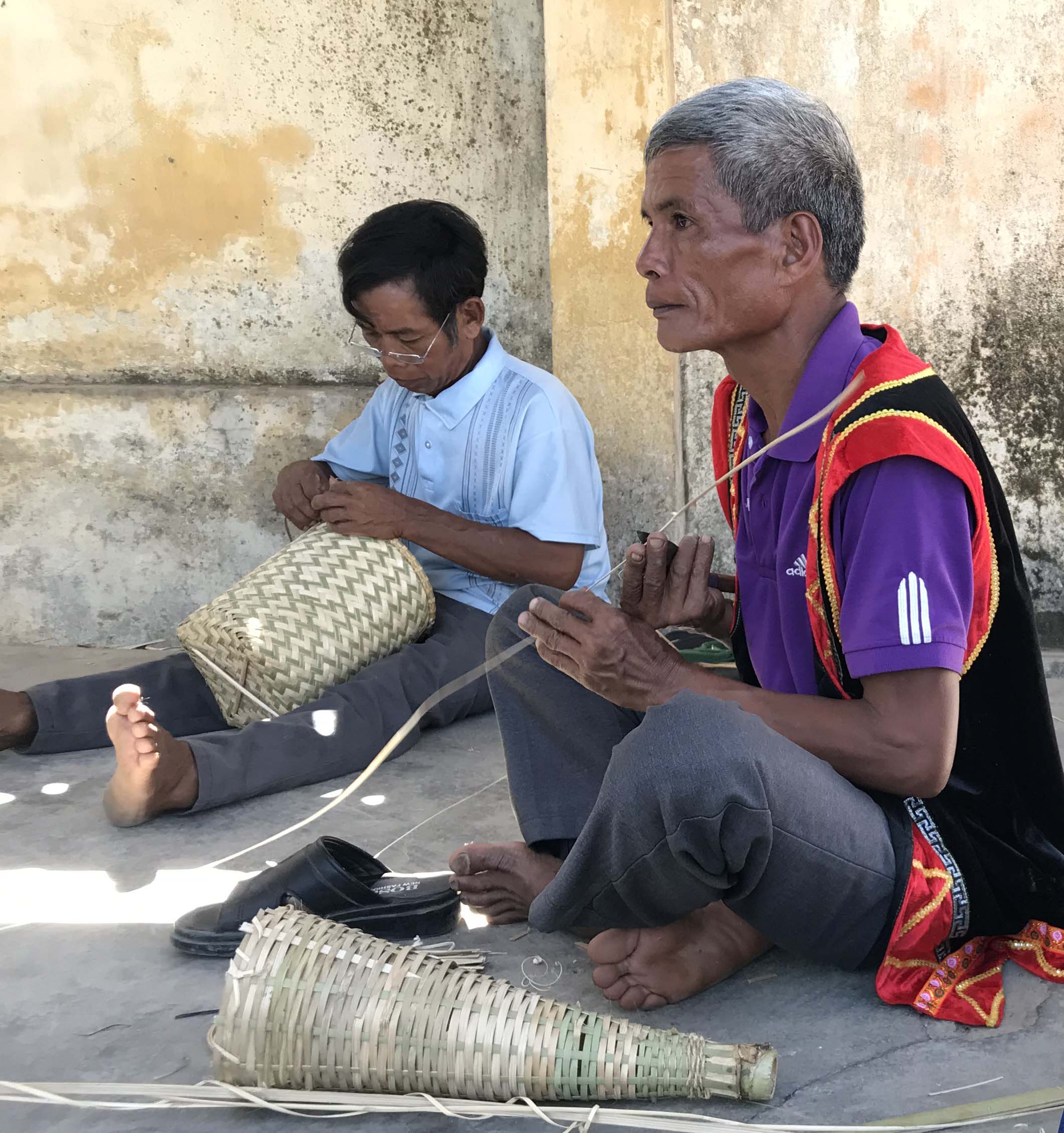 Ethnic people making fishing tools