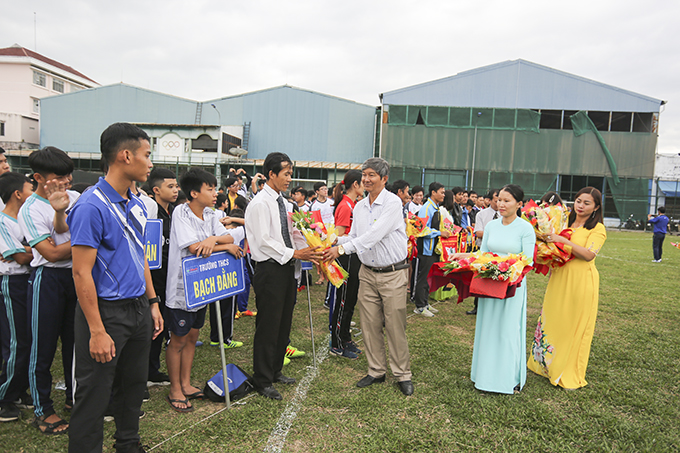 Organizer offering commemorative flags to participating units