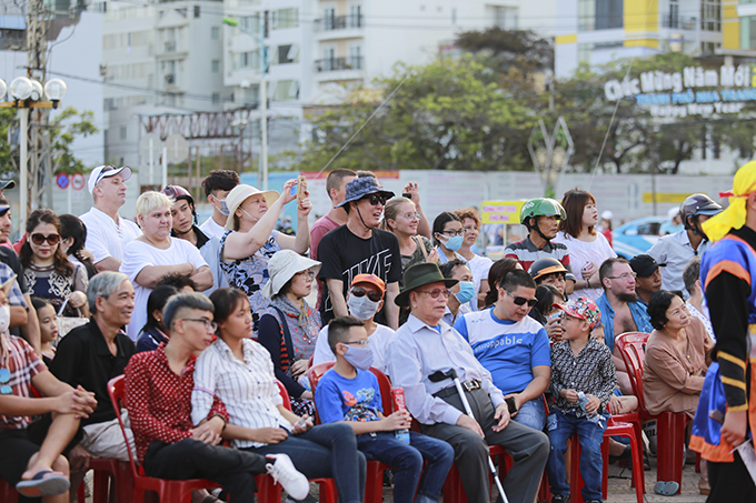 Locals and tourists watching human chess competition