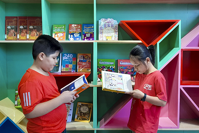 Children reading books at reading room at Pioneer International English Center