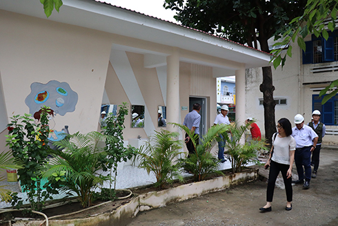 Delegation checking newly-built washroom at Vinh Hoa 1 Primary School