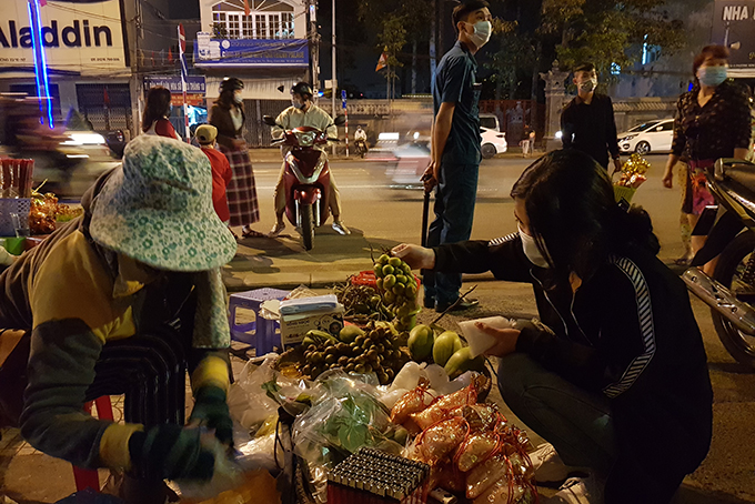 Buying “lucky things” in front of Long Son Pagoda