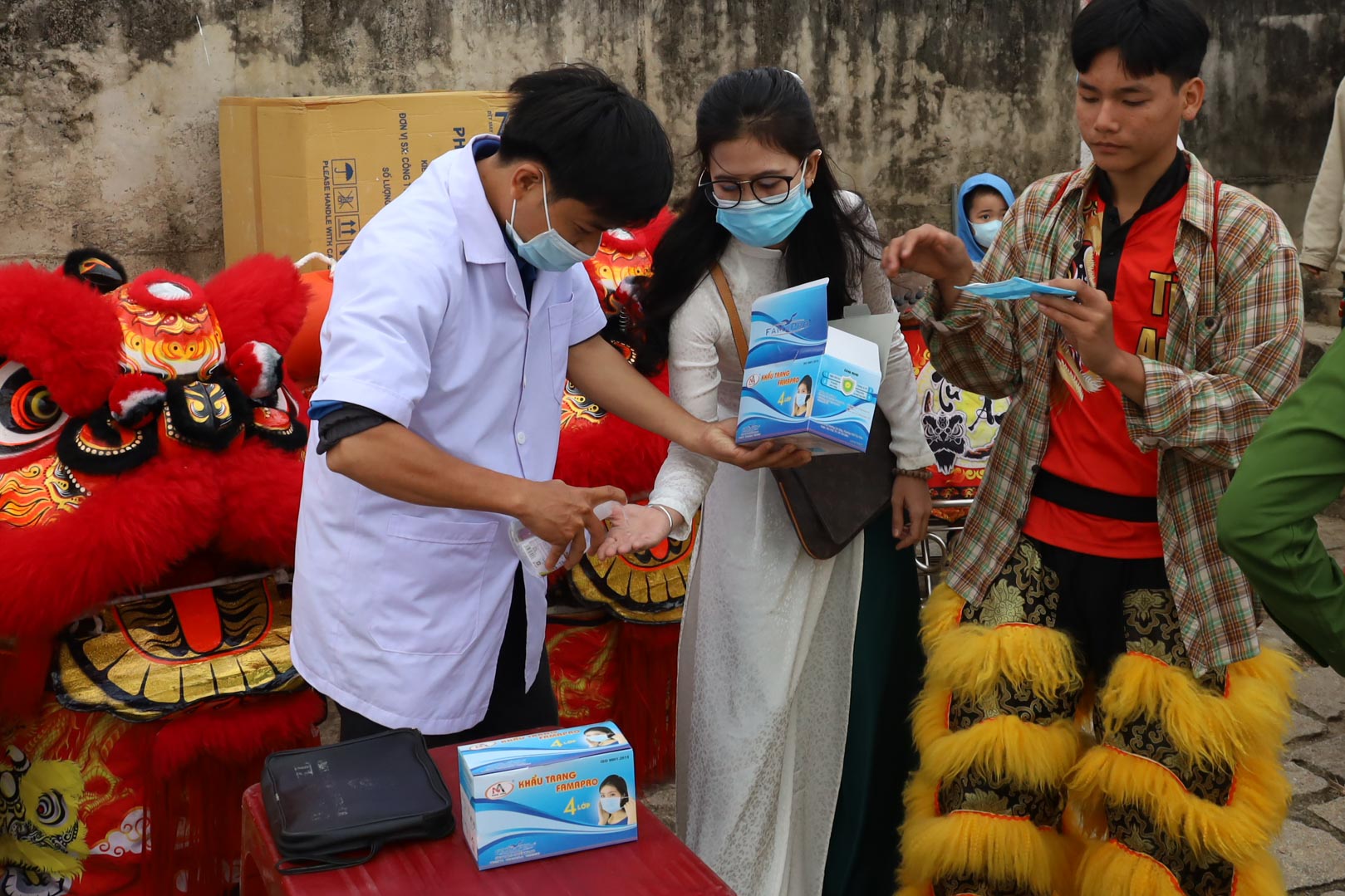 Participants wear masks and wash hands with hand sanitizer