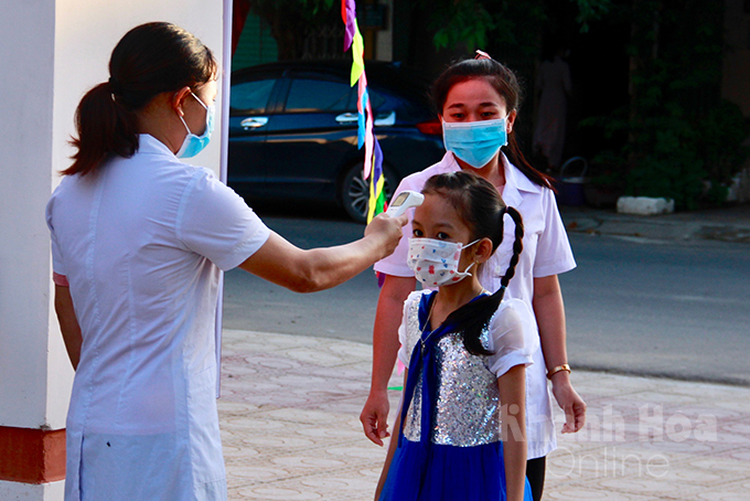 Checking student’s body temperature before opening ceremony