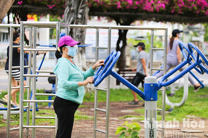 People exercising with equipment at a park