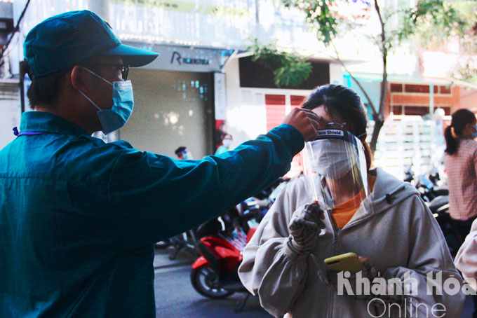 Taking temperature before vaccination.