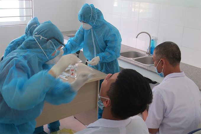 Taking sample for COVID-19 testing in Cam Ranh City