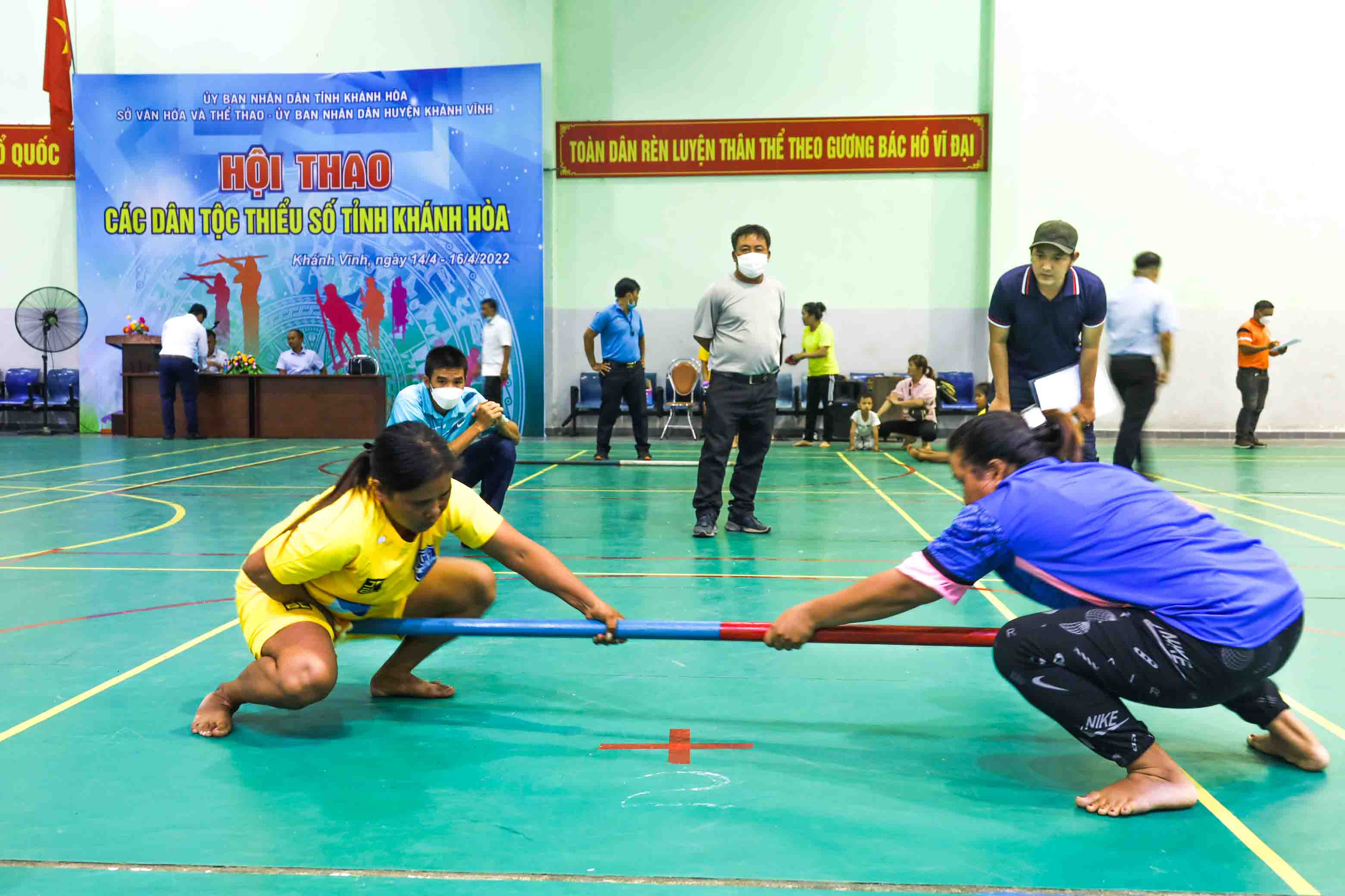 Players competing in stick pushing game 