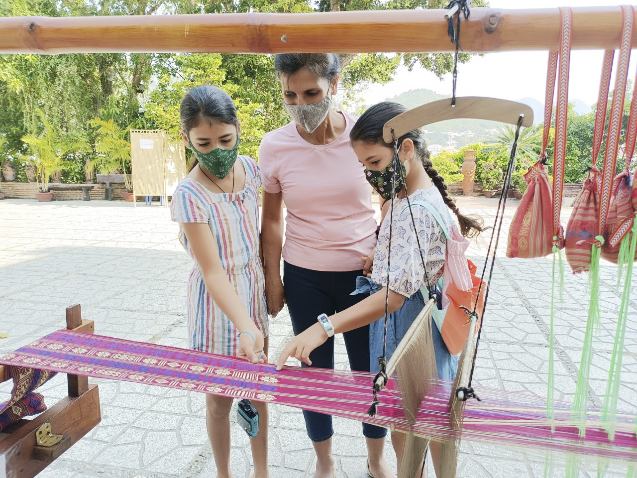 Indian tourists learn Cham brocade weaving techniques when visiting Ponagar Tower.