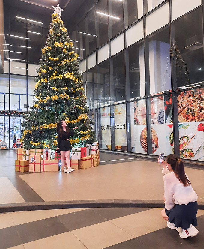 Posing with Christmas tree at AB Central Square