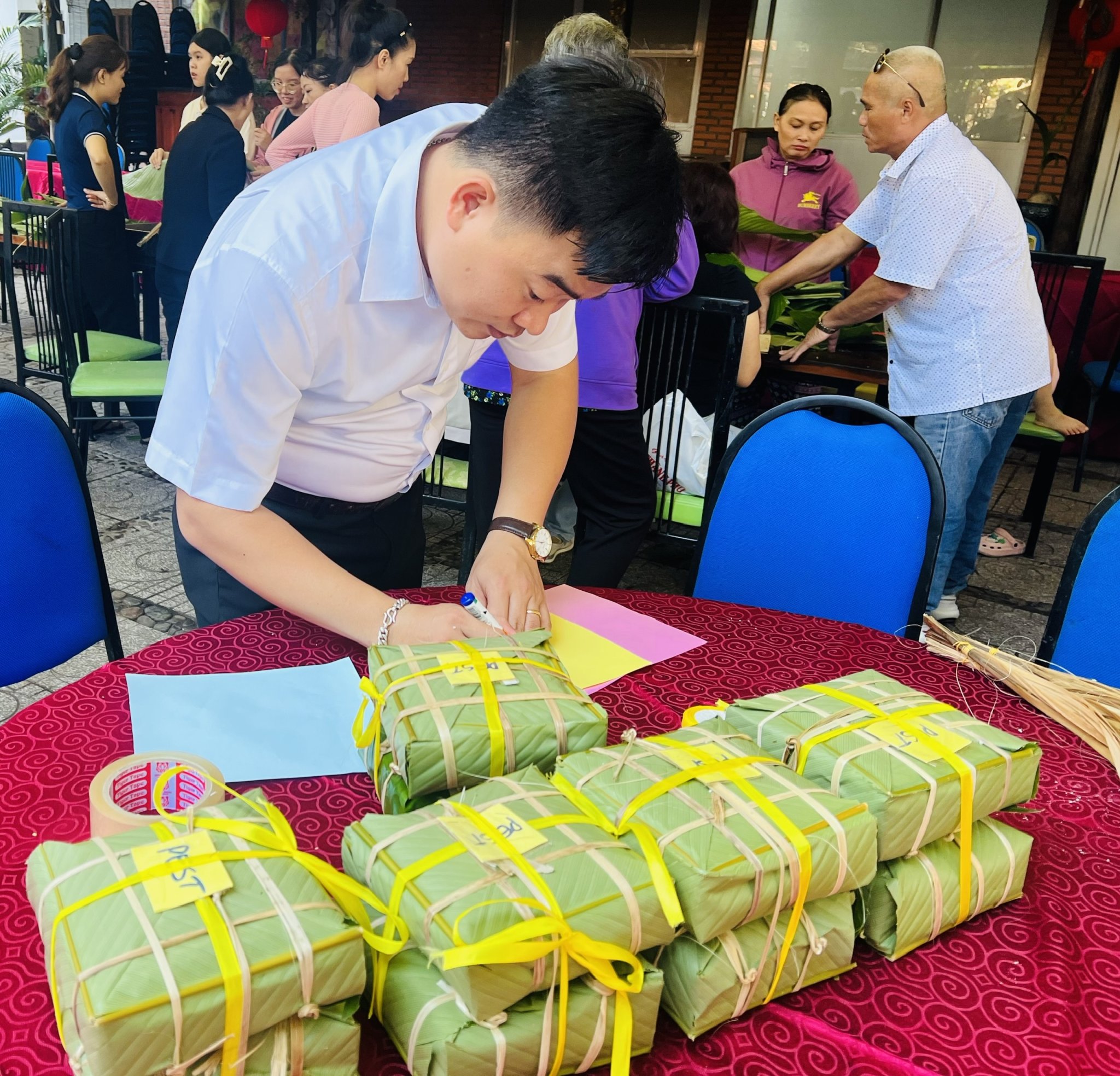 Staff of Yasaka Saigon Nhatrang Hotel marking “banh chung” of guests