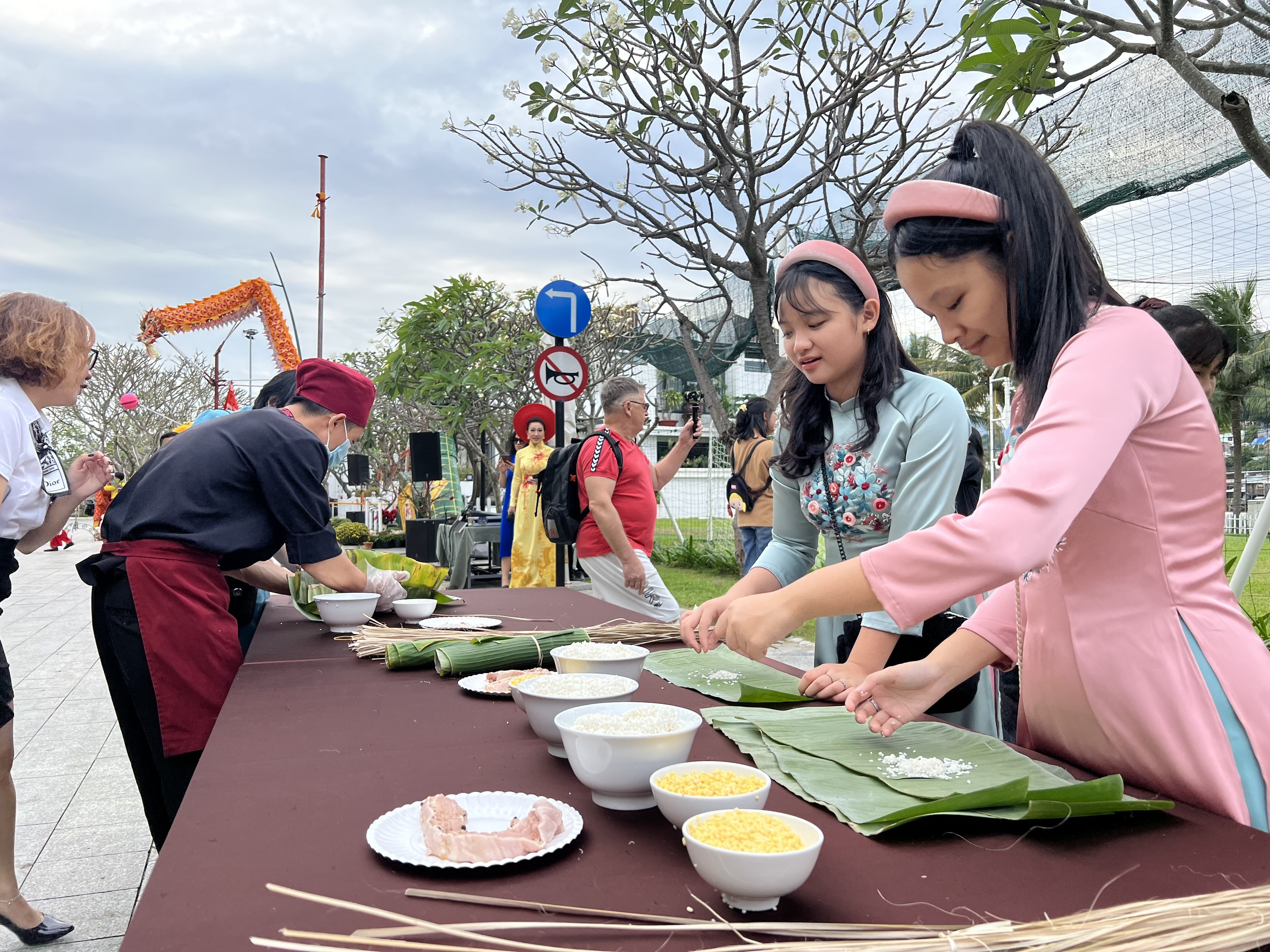 Children in Ao dai making  "banh Tet "