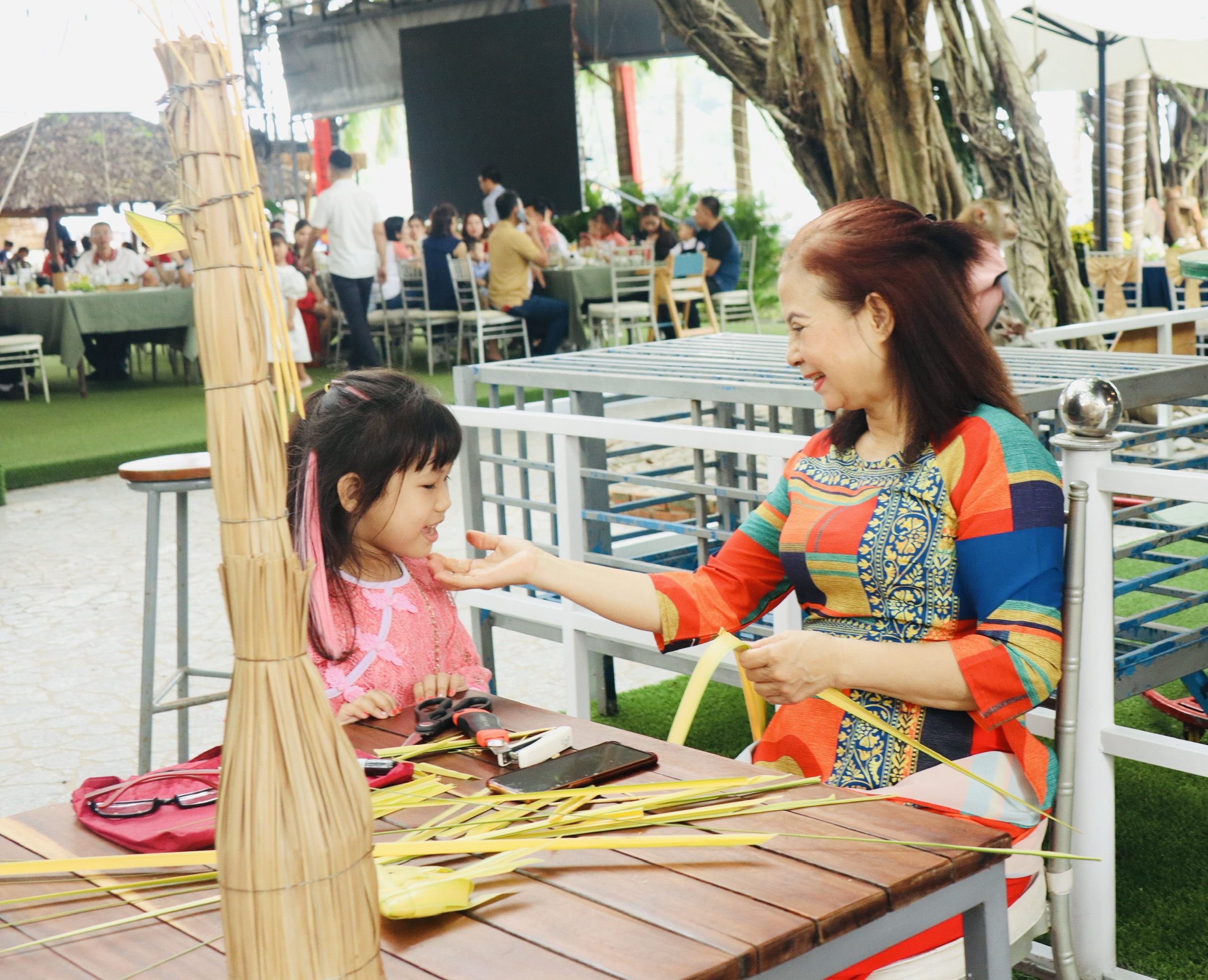 Beautiful moment between an artisan, who makes coconut leaf toys, and a child